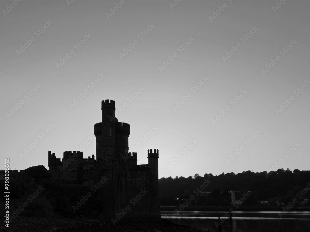 Fototapeta premium Blackrock castle observatory silhouette in the rays of sunset sun black and white monochrome background