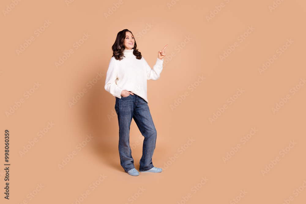 Photo of pretty lovely senior woman wear stylish clothes look empty space isolated on beige color background Photo of pretty lovely senior woman wear stylish clothes look empty space isolated on beige color background
