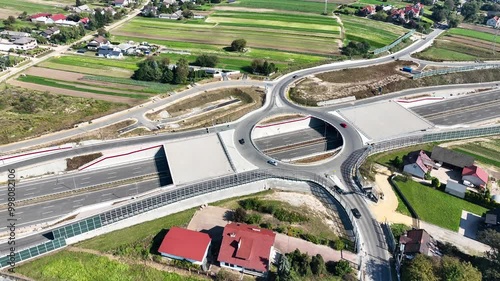 Krakow, Poland. Batowice highway junction in construction on S53. part of motorway freeway around Cracow. Traffic circle with a hole inside, viaducts, tunnels and ramps. September 2024. Aerial view photo