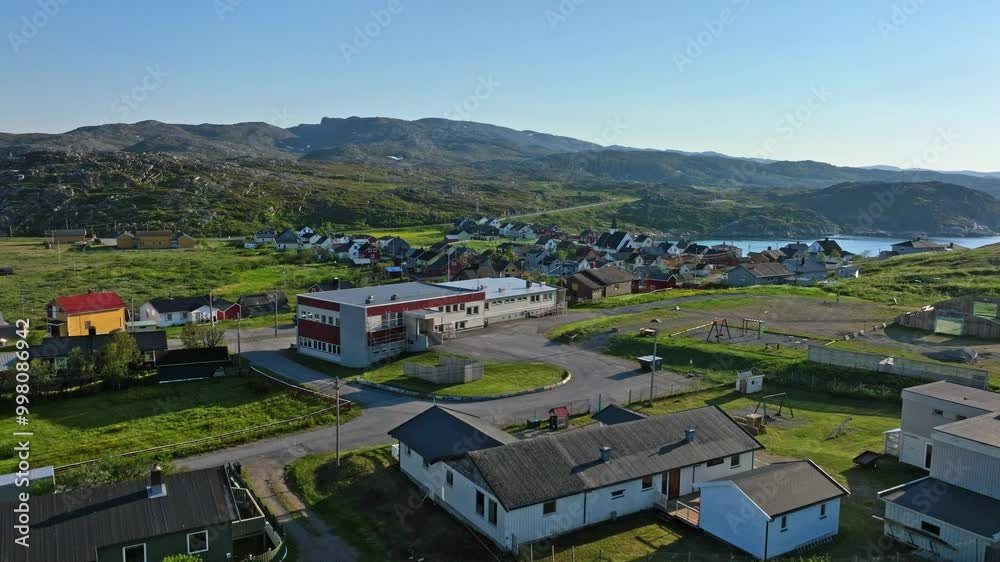Aerial view rising in front of the Bugøynes village, summer day in north Norway Aerial view rising in front of the Bugøynes village, summer day in north Norway
