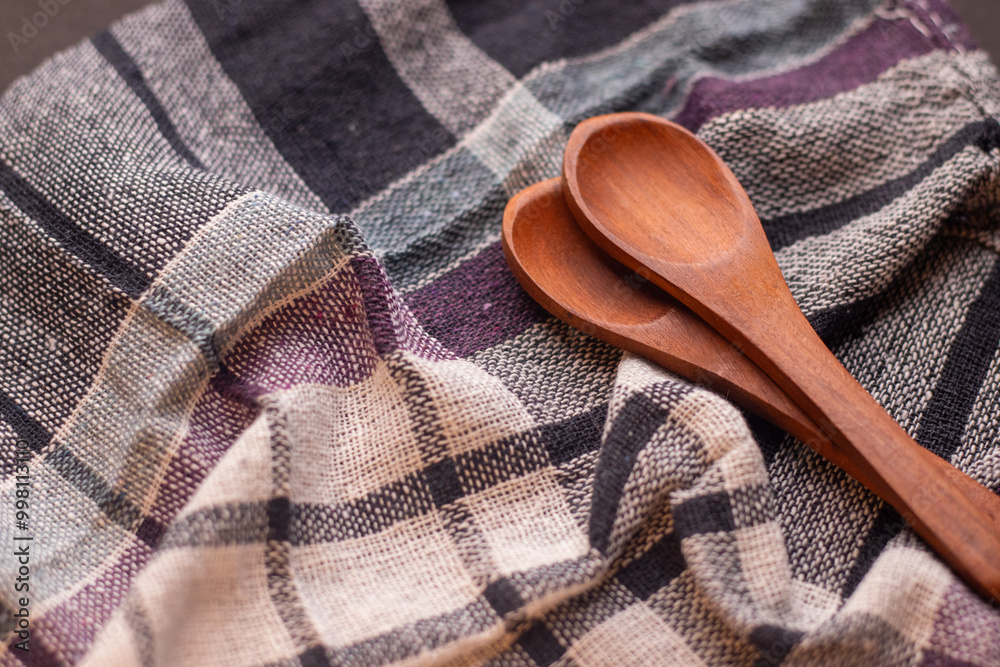 Flat lay picture of 2 empty wooden spoons kept on a cloth background in a studio Flat lay picture of 2 empty wooden spoons kept on a cloth background in a studio