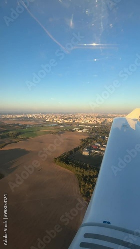 View of the city from the airplane cockpit, private flight. Aeroclub. Vertical video. 