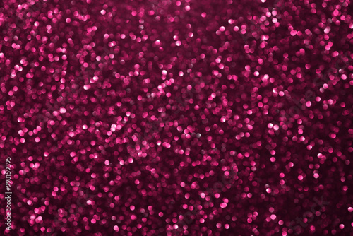 Pink glitter bokeh background with defocused sparkling lights, abstract shiny texture. Holiday lights.