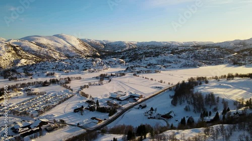 Drone shot over Sirdal Agder Norway at winter with blue skies and low sun photo