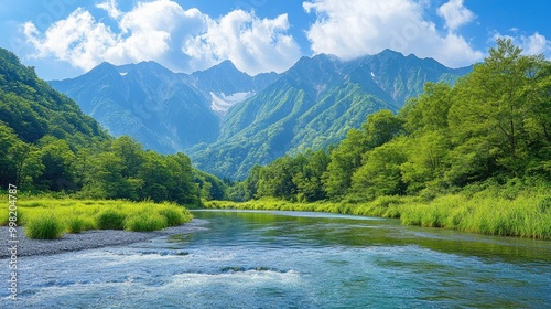 Fresh greenery surrounds the Azusa River in Kamikachi, with the towering Hotaka Mountains providing a stunning contrast in this beautiful, natural landscape. photo