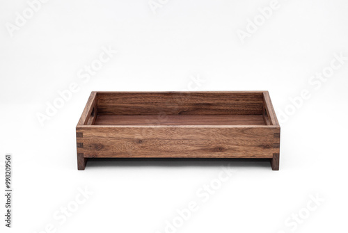 Solid walnut wood tray with dovetail joints and cutout handles on the sides for easy carrying on white background