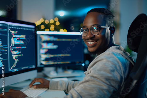 Man computer programmer focused on solving coding challenges in a dynamic multi-ethnic team office environment