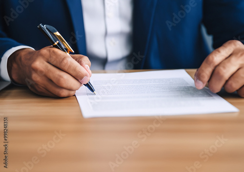 businessman sitting at desk holds pen signing contract paper, lease mortgage, employment hr or affirm partnership 