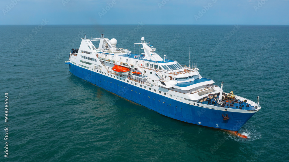 Traditional old passenger ship at anchor. Blue hull, white superstructure. Aerial view. Traditional old passenger ship at anchor. Blue hull, white superstructure. Aerial view.