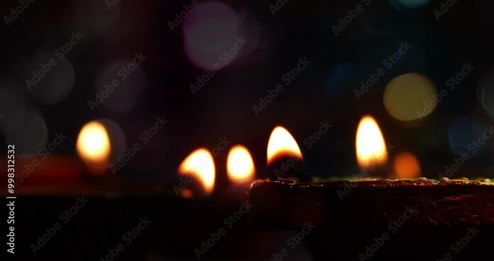 Macro view of flickering oil lamps with blurred background, showcasing a soft and warm ambiance perfect for backdrops Macro view of flickering oil lamps with blurred background, showcasing a soft and warm ambiance perfect for backdrops
