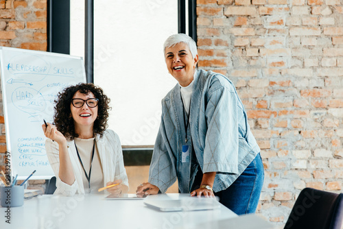 Confident female business partners collaborating in a sleek corporate atmosphere photo