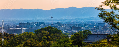 The famous tourist attraction, Kyoto Tower and the surrounding city of Kyoto glow in the sunlight during an late summer afternoon.