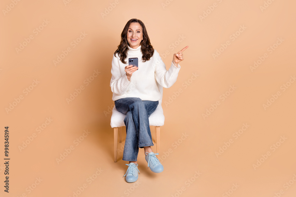 Photo of charming pretty woman wear white trendy clothes recommend empty space isolated on beige color background Photo of charming pretty woman wear white trendy clothes recommend empty space isolated on beige color background