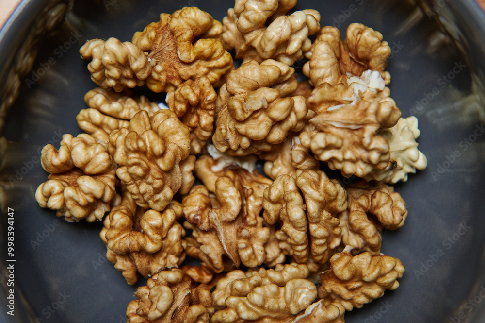 Close-up of Organic Walnut Kernels in a Bowl. Healthy eating and vegan concept. Close-up of Organic Walnut Kernels in a Bowl. Healthy eating and vegan concept.