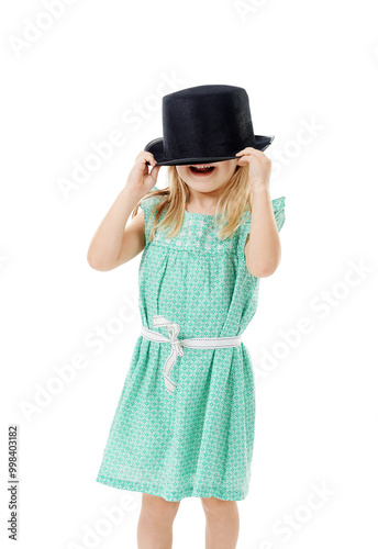 Studio, hide and girl with hat for fashion, dress up and fantasy style for halloween concert. Childhood, young child and character with confidence for cool clothes, accessory and white background