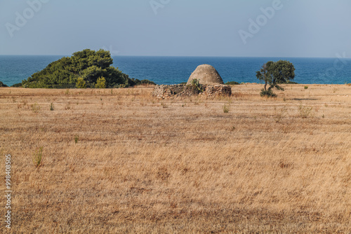 Old trulli houses near the coastline in Puglia