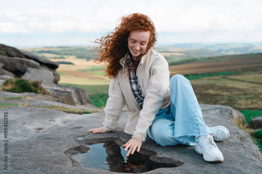 Joyful Girl Interacting With Natural Puddle on Scenic Rocky Landscape During Sunny Day Joyful Girl Interacting With Natural Puddle on Scenic Rocky Landscape During Sunny Day