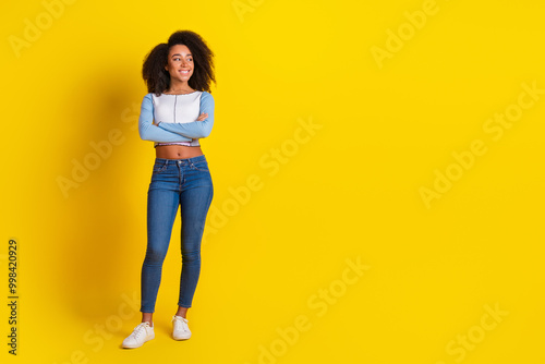 Full size photo of lovely girl dressed stylish shirt holding arms folded look empty space isolated on vibrant yellow color background