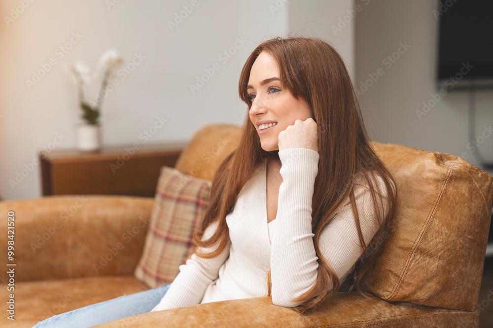 Young Woman Relaxes in Cozy Armchair, Lost in Thought During Tranquil Afternoon at Home Young Woman Relaxes in Cozy Armchair, Lost in Thought During Tranquil Afternoon at Home