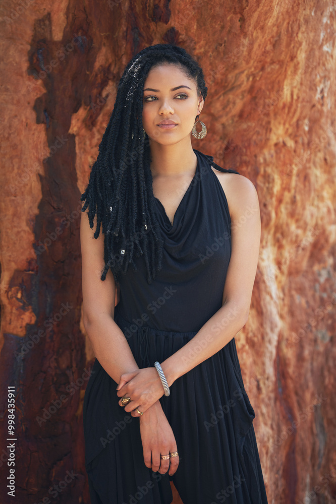 Fototapeta premium Serious, woman and fashion with braids outdoor for trendy clothes, cool jewellery or confidence of natural hair. Girl, relax and dreadlocks with creative outfit, unique accessories and culture style