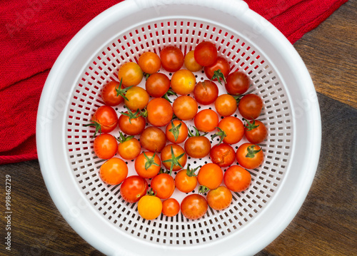 Organic cherry tomatoes in a white basket