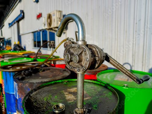 Old oil drums lined up in a chemical storage area. Oil suction cups and various types of oil drums. Diesel, gear oil and various types of lubricants. photo