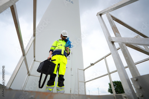 Maintenance engineer working at wind turbine farm