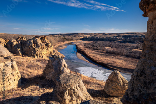 River winding through frozen prairie landscape with sandstone formations