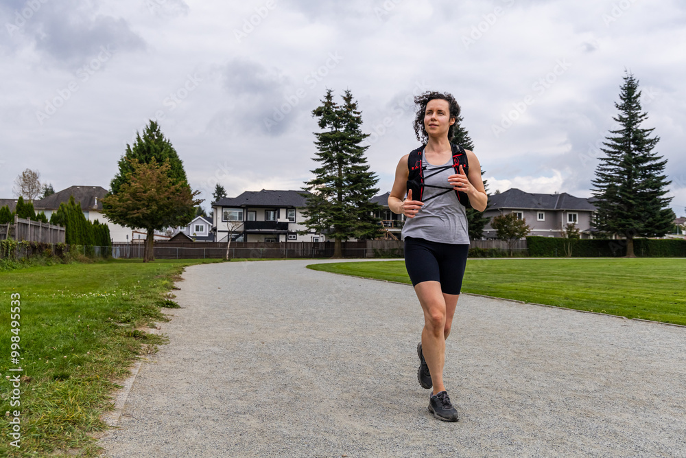 Woman Jogging on a Path in Mission, BC, Canada for a Healthy Outdoor Workout Woman Jogging on a Path in Mission, BC, Canada for a Healthy Outdoor Workout
