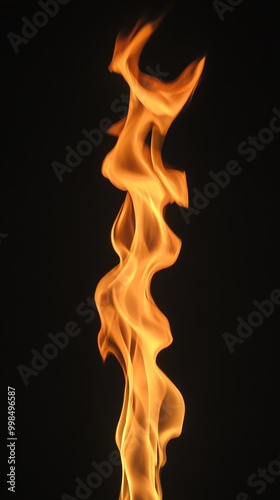 A mesmerizing flame flickers against a dark backdrop, showcasing the beauty and energy of fire in a dynamic display.