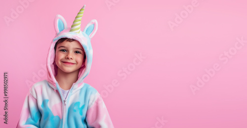 Boy in unicorn kigurumi pajamas.