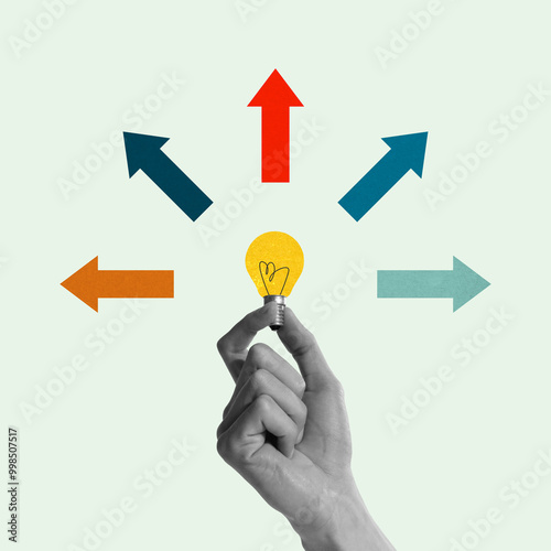 Hand holding glowing lightbulb with multicolored arrows pointing in multiple directions, representing new ideas and many creative paths. Contemporary art. Concept of business, progress, achievement photo