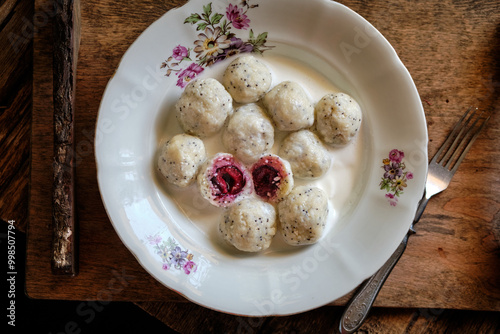 lazy dumplings with poppy seeds and cherry filling with cream sauce