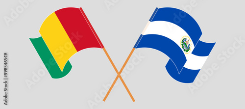 Crossed and waving flags of Guinea and Republic of El Salvador. Vector illustration