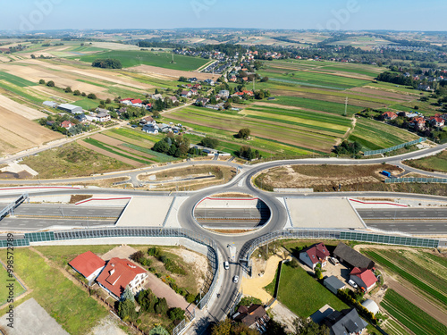 Obraz na płótnie Krakow, Poland. Batowice highway interchange in construction on S53. part of motorway ring road around Cracow. Traffic circle with a hole inside, viaducts, tunnels, ramps. September 2024. Aerial view w salonie