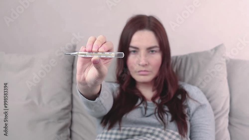 Wallpaper Mural Woman caught a cold, got sick, she shows mercury thermometer with a temperature of 37,7 C. Animated video footage Torontodigital.ca