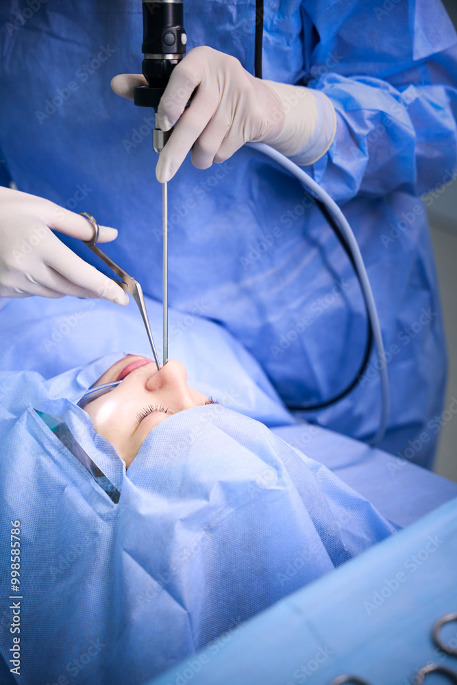 Clinic specialist uses modern technologies during an operation Clinic specialist uses modern technologies during an operation