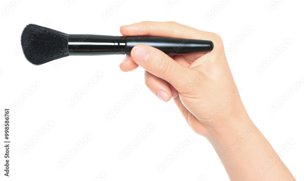 Woman hand holds black cosmetics brush, isolated on transparent background, cosmetics and visage concept Woman hand holds black cosmetics brush, isolated on transparent background, cosmetics and visage concept