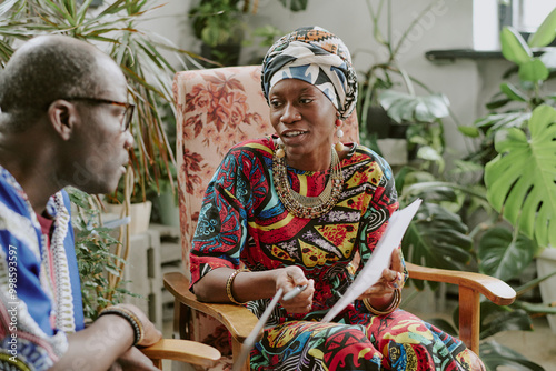 Female African American subordinate talking to her boss about new project idea photo