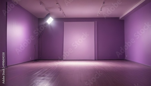 A dimly lit room with purple walls and a wooden floor, featuring a large white panel and a spotlight on the left wall