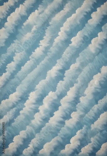 a diagonal pattern of fluffy white clouds against a light blue sky