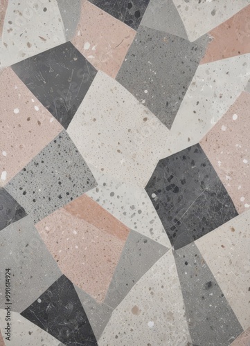 a close-up view mosaic pattern composed of irregularly shaped tiles in various shades of gray, beige, and peach, with some darker tones