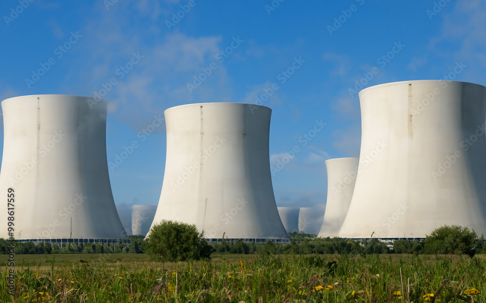AI-generated nuclear power plant set on a vibrant green grass field AI-generated nuclear power plant set on a vibrant green grass field