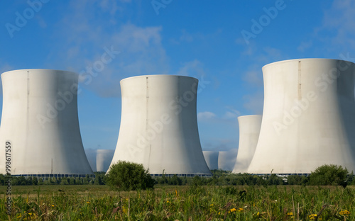 AI-generated nuclear power plant set on a vibrant green grass field