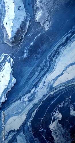 a close-up view marble surface with a swirling pattern of blue and white hues, resembling the movement of water or a natural landscape photo