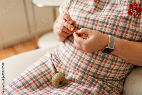 Hands of a senior woman crocheting captured in close-up