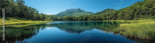 Serene View of Mt. Haruna Surrounded by Lush Greenery Under a Clear Blue Sky in Tranquil Nature photo