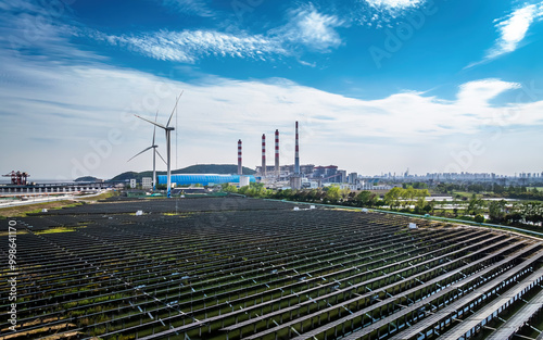 Solar panels and wind turbines with chimneys of power plants