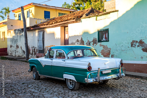 old green and white classic car on the street of trinidad cuba