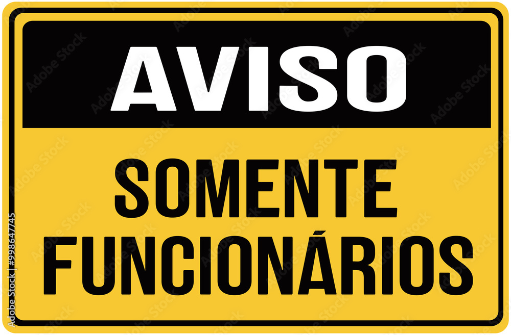 Fototapeta premium A sign in black and yellow color that warns in portuguese language : notice stafgf only